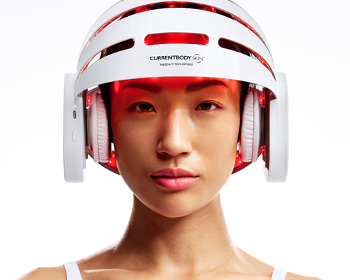 Woman wearing Currentbody LED Hair growth helmet