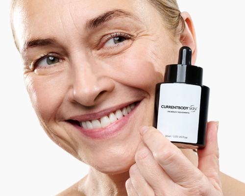 Woman holding the CurrentBody Skin Green Tea Serum